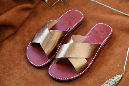 Elegant handmade golden leather sandals with a criss-cross design and a touch of Moroccan artistry