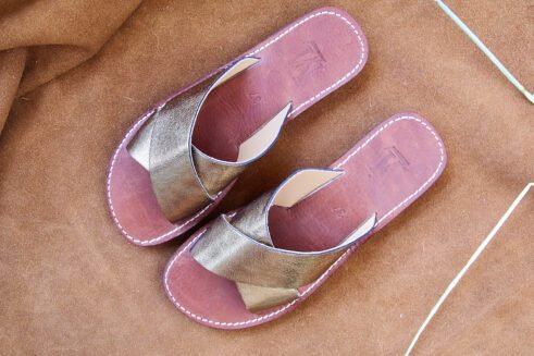 Elegant handmade golden leather sandals with a criss-cross design and a touch of Moroccan artistry