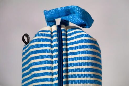 Blue and white striped cosmetic pouch with a zipper closure and a small handle.