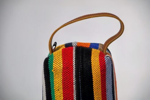Colorful striped cosmetic pouch with handle, perfect for organizing your beauty essentials.