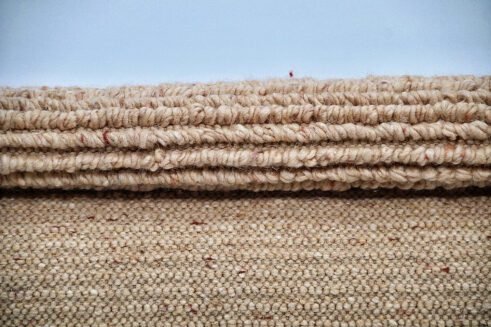 Handcrafted Moroccan wool rug in warm golden tones, featuring a subtle texture and elegant design, perfect for adding sophistication to any room