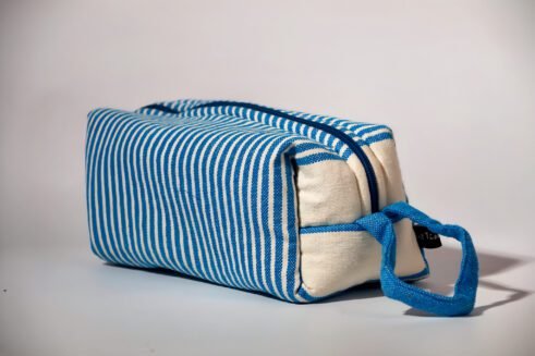 Blue and white striped cosmetic pouch with a zipper closure and a small handle.