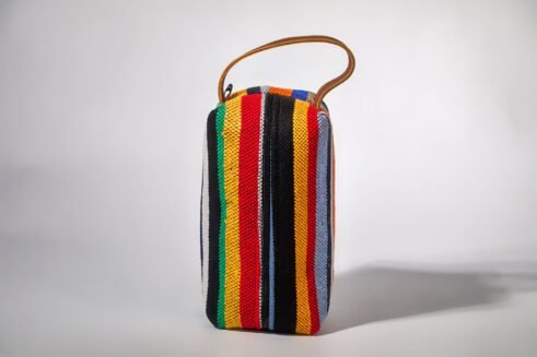Colorful striped cosmetic pouch with handle, perfect for organizing your beauty essentials.