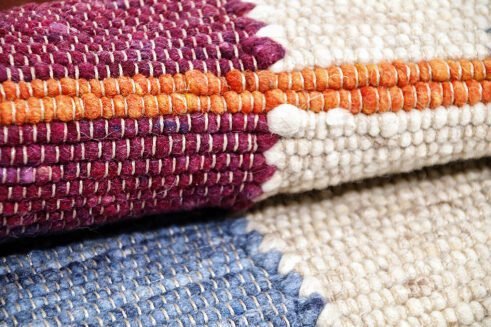 Handwoven Moroccan wool rug with vibrant geometric patterns, blending tradition and modern aesthetics for a stylish addition to any home