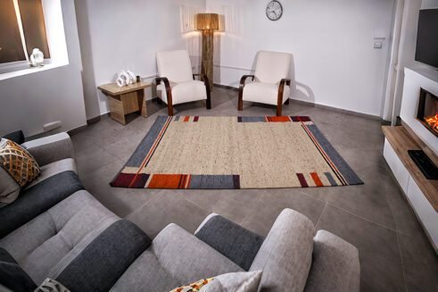 Handwoven Moroccan wool rug with vibrant geometric patterns, blending tradition and modern aesthetics for a stylish addition to any home