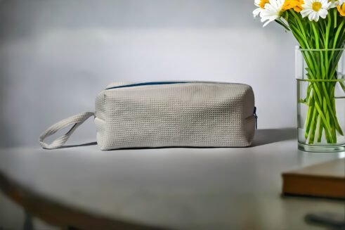White waffle weave cosmetic pouch with a blue zipper, designed for travel and everyday use.