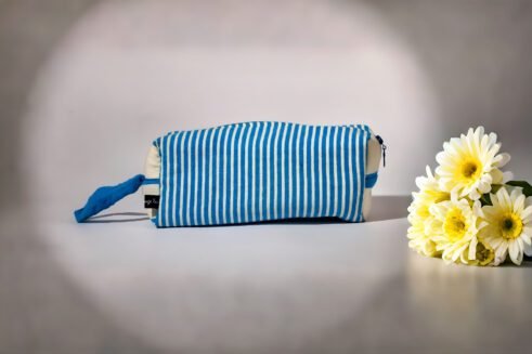 Blue and white striped cosmetic pouch with a zipper closure and a small handle.