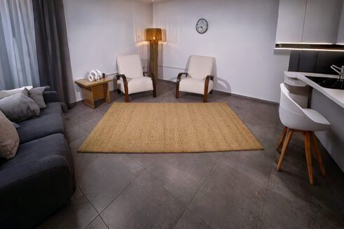 Handcrafted Moroccan wool rug in warm golden tones, featuring a subtle texture and elegant design, perfect for adding sophistication to any room
