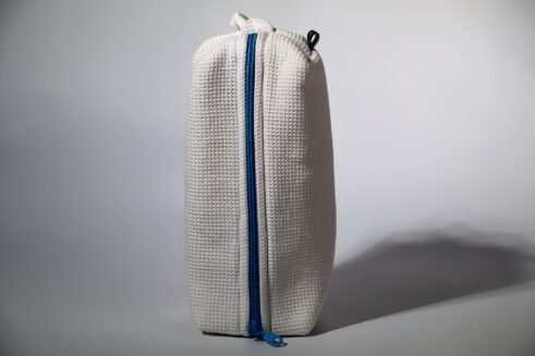White waffle weave cosmetic pouch with a blue zipper, designed for travel and everyday use.