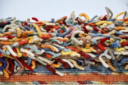 Handcrafted Moroccan multi-color wool rug with a rich, textured surface that brings warmth and style to any space